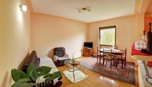 a living room with a couch and a table at Smestaj Rakovic in Pribojska Banja