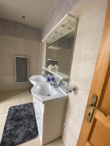 a bathroom with a sink and a mirror at Maison luxe entier a Limay in Limay +11 photos