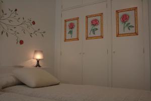 a bedroom with two closets with roses on the walls at Apartamentos La Casa Pintada in Cáceres