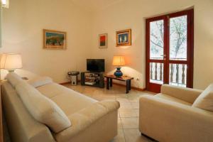 a living room with two couches and a television at Casa Procchio in Procchio