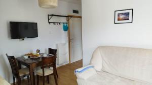 a living room with a white couch and a table at Messembria Resort in Sunny Beach +32 photos