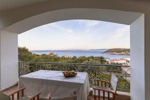 a table with a bowl of fruit on a balcony at Eternal Summer Time Villa for 6 in Dhaskalión