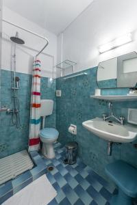 a bathroom with a sink and a toilet and a shower at Hotel Manto in Naousa
