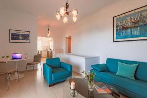 a living room with a blue couch and a table at Eternal Summer Time Villa for 6 in Dhaskalión