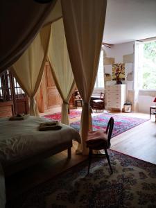 a bedroom with a bed and a chair in a room at Mulé in Lagardère