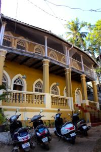 a group of scooters parked in front of a building at Royal Phoenix Inn in Panaji
