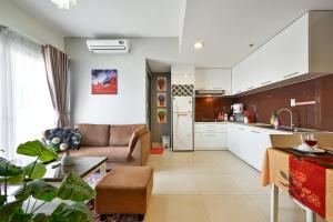 a kitchen and living room with a couch and a table at Landmark View 2 bedrooms condo in T1 Masteri Thao Dien, Fully Furnished With Full Amenities in Ho Chi Minh City