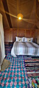 a bedroom with two beds in a tent at Krich Camp in Merzouga