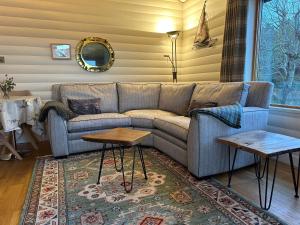 a living room with a couch and two tables at SAORSA CABIN in Lochinver