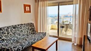 a living room with a couch and a balcony at EUROPA I - Playa de Miramar in Miramar