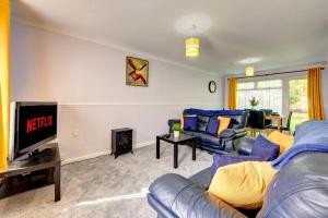 a living room with a couch and a tv at Park View - sleeps 7 great for 5 contractors in Warrington