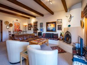 a living room with a couch and a fireplace at Cielo Grande 305, 2 Bedrooms, HDTV, Pet Friendly, Sleeps 6 in Santa Fe