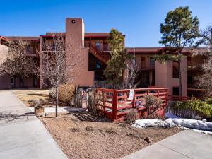 a building with a red fence in front of it at Cielo Grande 305, 2 Bedrooms, HDTV, Pet Friendly, Sleeps 6 in Santa Fe