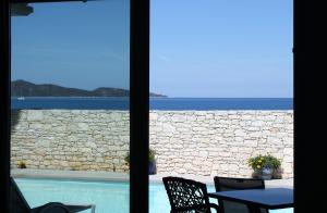 a view of the ocean from a patio with a table and chairs at Appart Bleu Azur in Saint-Florent
