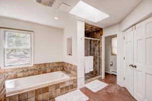 a bathroom with a tub and a window at Moonstar, 4 Bedrooms, Sleeps 10, Pet Friendly, Fireplace, Views, WiFi in Santa Fe
