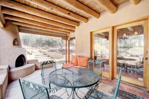 a patio with a table and chairs and a fireplace at Moonstar, 4 Bedrooms, Sleeps 10, Pet Friendly, Fireplace, Views, WiFi in Santa Fe