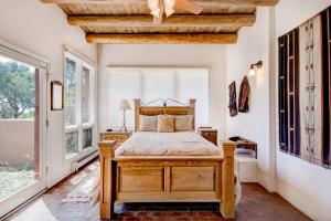a bedroom with a bed in a room with windows at Moonstar, 4 Bedrooms, Sleeps 10, Pet Friendly, Fireplace, Views, WiFi in Santa Fe