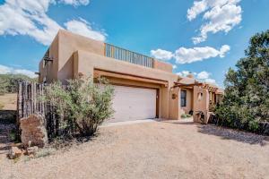 a home in the desert with a garage at Moonstar, 4 Bedrooms, Sleeps 10, Pet Friendly, Fireplace, Views, WiFi in Santa Fe