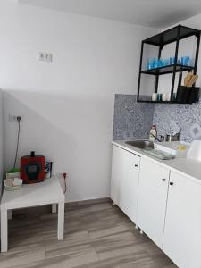 a kitchen with a sink and a counter with a microwave at Olimp sea view in Olimp