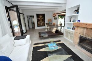 Una sala de estar con un sofá blanco y una chimenea. en Casa Markoli, en Jávea