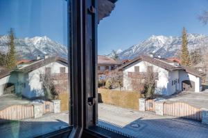 a view from a window of houses and mountains at Ruhige Ferienwohnungen in Partenkirchen 1 in Garmisch-Partenkirchen