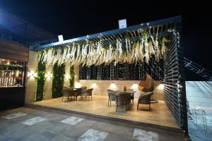 a restaurant with tables and chairs on a patio at Hotel Pradeep Star Inn in Gorakhpur