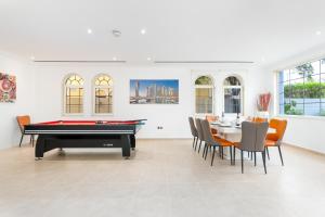 a billiard room with a pool table and chairs at 6 plus 1 Bdr Villa Jumeirah Park with Amz Climatized huge private pool - 5 min from Jbr beach in Dubai