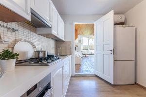 a kitchen with white cabinets and a white refrigerator at Countryside apartment in Foinikiá