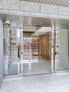 wejście do budynku ze szklanymi drzwiami w obiekcie 大阪谷町橋の宿 w Osace