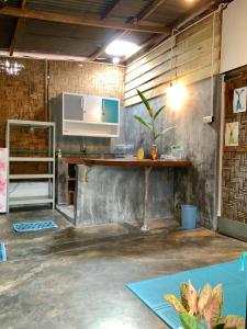 a room with a table and a counter in a room at Homestay Bukit Lawang in Bukit Lawang