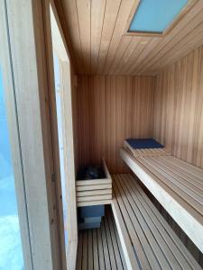 a small wooden sauna with two beds in it at Villas Vairocana in Santillana del Mar
