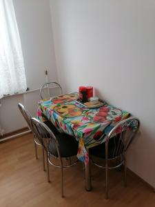 a table with chairs and a table cloth on it at Centrum One in Suwałki