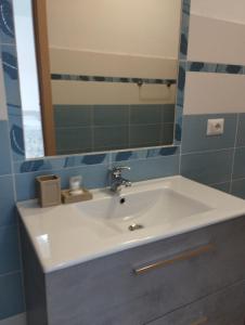 a bathroom with a white sink and a mirror at Affitta Camere Zio Peppe in San Teodoro