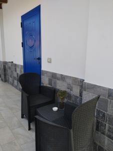a table and chairs with a blue door at Affitta Camere Zio Peppe in San Teodoro +31 photos