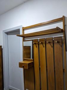 a wooden closet with ajar doors in a room at Communist style room in Shkodër