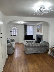 a living room with two couches and a television at 14 crouch road in Burnham on Crouch