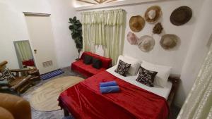 a bedroom with a bed with red sheets and pillows at Chateau De Aow in Carles