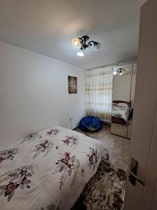 a bedroom with a bed and a room with a mirror at Dovali apartment in Râmnicu Vâlcea