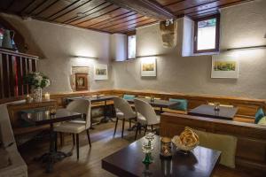 - un restaurant avec des tables et des chaises dans une salle dans l'établissement Hôtel De La Couronne, à Riquewihr