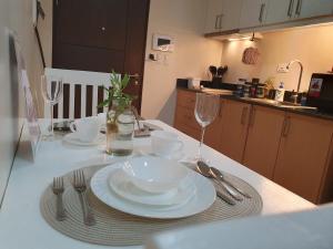 a table with plates and silverware on a kitchen counter at Lafayette Park Square Condominium, Manduriao, Iloilo (15Z) in Iloilo City