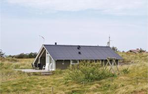 a small house on top of a hill at Holiday Home Hvide Sande 41 in Havrvig