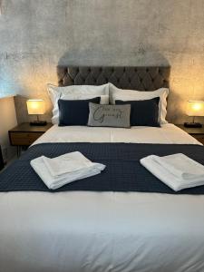 a bedroom with a large bed with towels on it at The Cottage in Saint Annes on the Sea