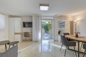 a living room and dining room with a table and chairs at Apartments Pino in Rovinj