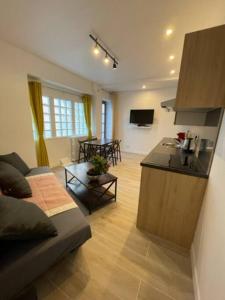 パリにあるParis Nordmann superbe appartement 2 piècesのキッチン、リビングルーム(ソファ、テーブル付)