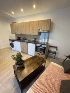 a living room with a table and a kitchen at Paris Nordmann superbe appartement 2 pièces in Paris