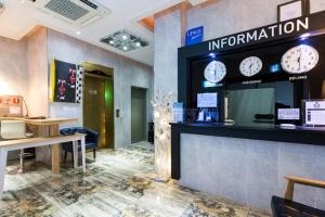 an office with a counter with clocks on the wall at Show Hotel Haeundae in Busan