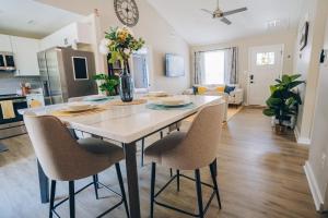 a kitchen and living room with a table and chairs at City Retreat - 4 Bedroom Oasis with King & Private Yard near Downtown in Charlotte