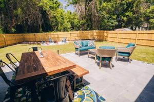 a patio with a wooden table and chairs at City Retreat - 4 Bedroom Oasis with King & Private Yard near Downtown in Charlotte