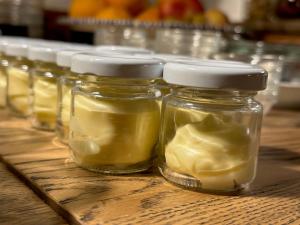 a row of jars of pickles on a wooden table at Hotel Adler - Weil am Rhein in Weil am Rhein