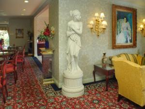 a statue of a woman standing in a room at Carlyle Hotel in Campbell